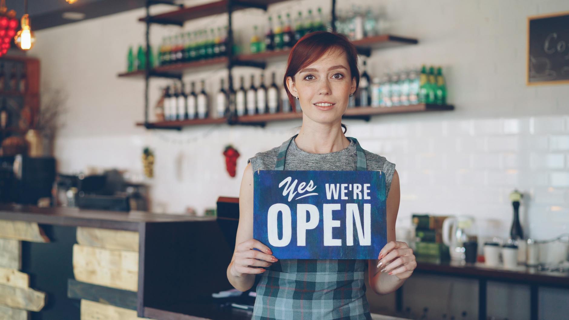Canadian small business owner working at their retail counter